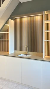 Cuisine sous escalier à Saint-Malo — mélaminé blanc · lattes en panneau décor · plan en compact, détail 1